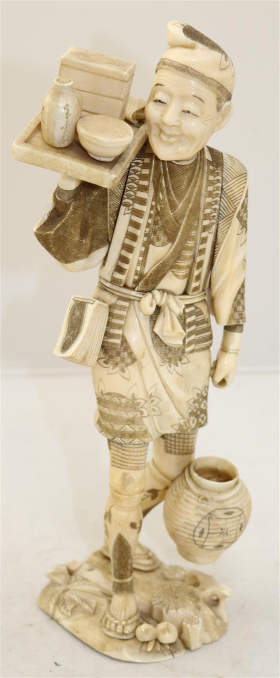 A large Japanese sectional walrus ivory figure of a man, early 20th century, 32cm